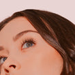 A close up of a woman's face, focusing on her eyes and lash extensions